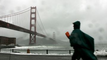SAN FRANCISCO - DECEMBER 28: A woman walks along the seawall at Fort Point near the Golden Gate Bridge December 28, 2005 in San Francisco. A series of wet winter storms is hitting the greater San Francisco Bay Area which has prompted flood warnings and high wind advisories. The storms are expected to last through the new year. (Photo by Justin Sullivan/Getty Images)