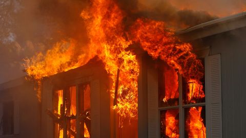 JAMUL, CA - OCTOBER 24: A home burns in Deerhorn Valley as the Harris Fire continues growing beyond 70,000 acres on October 24, 2007 near Jamul, California. Southern California is being ravaged by numerous record wildfires as Santa Ana Wind conditions push them into communities surrounded by native Chaparral habitat that has been dried by the driest rain season since records began 130 years ago. The fires are shaping up to be the worst wildfire event in San Diego County history. As many as 500,000 people have been evacuated from their homes. (Photo by David McNew/Getty Images)