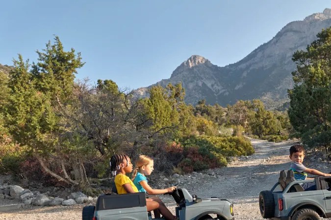 Foto de varios niños jugando en un Bronco de juguete