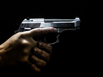 TOPSHOT - A man holds a gun at the 'Calibre 12' (Caliber 12) shooting club in Sao Goncalo, Rio de Janeiro, Brazil on September 03, 2018. - The liberation of the use of firearms is one of Brazilian far-right presidential candidate Jair Bolsonaro's flagships. (Photo by DANIEL RAMALHO / AFP) (Photo credit should read DANIEL RAMALHO/AFP via Getty Images)