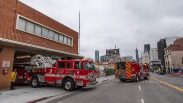 Fire trucks leave the LAFD Station No9 at Skid Row on April 12, 2020 in downtown Los Angeles, California. - One of the busiest fire station in the country , LA Fire Station 9 is on the front lines of California's homeless crisis e Coronavirus pandemic. (Photo by Apu GOMES / AFP) (Photo by APU GOMES/AFP via Getty Images)