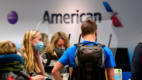 Travellers are seen at the American Airlines check-in counter at Los Angeles International Airport in Los Angeles, California in October 1, 2020. - American Airlines has announced it will start furlouging 19,000 employees today due to the ongoing coronavirus pandemic as the Payroll Suppport Program (PSP) under the CARES Act expires today. (Photo by Frederic J. BROWN / AFP) (Photo by FREDERIC J. BROWN/AFP via Getty Images)