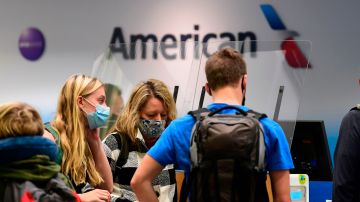 Travellers are seen at the American Airlines check-in counter at Los Angeles International Airport in Los Angeles, California in October 1, 2020. - American Airlines has announced it will start furlouging 19,000 employees today due to the ongoing coronavirus pandemic as the Payroll Suppport Program (PSP) under the CARES Act expires today. (Photo by Frederic J. BROWN / AFP) (Photo by FREDERIC J. BROWN/AFP via Getty Images)