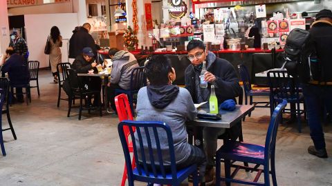 People enjoy lunch at Grand Central Market as indoor dining reopens in Los Angeles, on March 15, 2021. - Los Angeles and southern California is allowed to partially reopen indoor dining and movie theaters Governor Gavin Newsom announced last week, as the region hit key health criteria. Slammed by a brutal Covid-19 pandemic winter spike, California has seen a rapid decline in infection rates in recent weeks as a vaccination rollout has delivered at least one dose to nearly a fifth of residents. (Photo by Frederic J. BROWN / AFP) (Photo by FREDERIC J. BROWN/AFP via Getty Images)