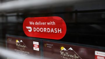 NEW YORK, NEW YORK - DECEMBER 04: A Doordash sticker is seen on a window at Mallenche Mexican Grill in the Flatbush neighborhood of Brooklyn on December 04, 2020 in New York City. Food delivery startup DoorDash Inc is expected to raise its U.S. initial public offering up to $3.14 billion. (Photo by Michael M. Santiago/Getty Images)