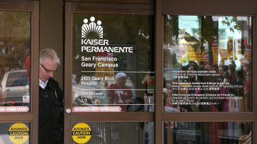 SAN FRANCISCO, CA - NOVEMBER 11: A security guard looks through a window as nurses strike outside of Kaiser Permanente hospital on November 11, 2014 in San Francisco, California. Nearly 18,000 Kaiser Permanente nurses in Northern California are staging a two-day strike amidst contract negotiations and to demand better working conditions, training and optimal safeguards for treating ebola. (Photo by Justin Sullivan/Getty Images)