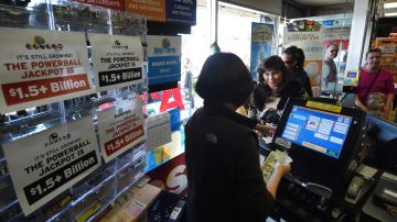 People line up to buy California Powerball lottery tickets at the famous Bluebird Liquor store, considered to be a lucky retailer of tickets, in Hawthorne, California on January 13, 2016. Record sales drove up the largest jackpot in US history to a whopping $1.5 billion as people dreaming of riches flocked across state lines and international borders to buy tickets. / AFP / MARK RALSTON (Photo credit should read MARK RALSTON/AFP via Getty Images)