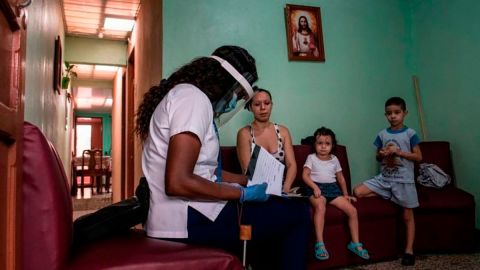 Una trabajadora del sector de la salud le daba información, en julio de 2020, a una familia sobre la prueba de detección de covid-19, en su hogar.