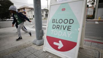 LOS ANGELES, CALIFORNIA - MARCH 19: A sign advertises a blood drive being held in a blood mobile outside Cedars-Sinai Medical Center on March 19, 2020 in Los Angeles, California. The American Red Cross declared there is ‘severe blood shortage’ as hundreds of community blood drives have been cancelled due to the COVID-19 pandemic. Normally blood drives occur in public places such as schools and churches, most of which are now closed. People with coughs, fevers, coughs, runny noses or shortness of breath are not allowed to donate and the number of people allowed inside the blood mobile is limited for safety. (Photo by Mario Tama/Getty Images)