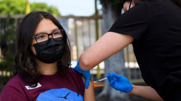 Audrey Romero, 16, receives a first dose of the Pfizer Covid-19 vaccine at a mobile vaccination clinic at the Weingart East Los Angeles YMCA on May 14, 2021 in Los Angeles, California. - The campaign to immunize America's 17 million adolescents aged 12-to-15 kicked off in full force on May 13. The YMCA of Metropolitan Los Angeles is working to overcome vaccine hesitancy and expand access in high risk communities with community vaccine clinics in the area. (Photo by Patrick T. FALLON / AFP) (Photo by PATRICK T. FALLON/AFP via Getty Images)