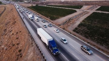 An aerial picture taken on August 26, 2021, shows trucks, cars, and other vehicles sitting in traffic due to road construction on Interstate 5 as they transit through the Tejon Pass from the Grapevine in Kern County, California . - Biden and his Democratic allies controlling the chamber are pushing for passage of both a $1.2 trillion overhaul to the country's infrastructure and a bill costing $3.5 trillion over 10 years that would pay for improvements to education, health care and climate change resiliency. (Photo by Patrick T. FALLON / AFP) (Photo by PATRICK T. FALLON/AFP via Getty Images)