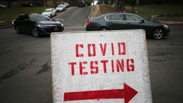 LOS ANGELES, CALIFORNIA - DECEMBER 07: Vehicles line up to enter a COVID-19 testing site at Dodger Stadium on the first day of new stay-at-home orders on December 7, 2020 in Los Angeles, California. Under state order, 33 million residents of California have entered into regional shutdowns in an attempt to contain the spread of the coronavirus as ICU capacity has dipped below 15 percent in most regions of the state. Barbershops, hair and nail salons, museums, zoos, movies theaters are closed while restaurants are open for takeout or delivery only. (Photo by Mario Tama/Getty Images)