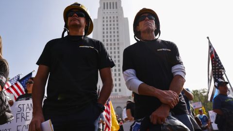 LOS ANGELES, CALIFORNIA - NOVEMBER 08: Los Angeles County firefighters stand in Grand Park at a ‘March for Freedom’ rally demonstrating against the L.A. City Council’s COVID-19 vaccine mandate for city employees and contractors on November 8, 2021 in Los Angeles, California. The City Council has set a deadline of December 18 for all city employees and contractors to be vaccinated except for those who have religious or medical exemptions. (Photo by Mario Tama/Getty Images)