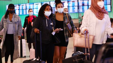 LOS ANGELES, CALIFORNIA - DECEMBER 03: International passengers arrive on the first day of a new rapid COVID-19 testing site for arriving international passengers at Los Angeles International Airport (LAX) on December 3, 2021 in Los Angeles, California. The free voluntary tests are being offered to arriving passengers in the Tom Bradley International Terminal by the Los Angeles County Department of Health after the county confirmed its first case of the Omicron variant December 2. (Photo by Mario Tama/Getty Images)