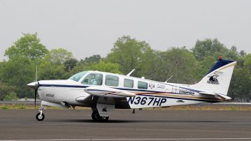 US pilot Matt Guthmiller (19) sits in the cockpit of his single-engined Beechcraft A36 Bonanza aircraft on the runway prior to lift-off from the Dr Babasaheb Ambedkar International Airport in Nagpur on June 27, 2014. A 19-year-old US citizen attempting to become the youngest person ever to fly around the world solo reached India July 26 with the bespectacled teen set to cover 29,000 miles (46,700 kilometres) during his journey, making 25 stops across 14 countries. AFP PHOTO/Noah SEELAM (Photo credit should read NOAH SEELAM/AFP via Getty Images)