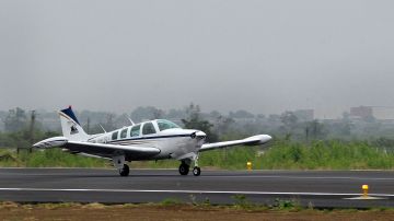 US pilot Matt Guthmiller (19) takes off in his single-engined Beechcraft A36 Bonanza aircraft from the Dr Babasaheb Ambedkar International Airport in Nagpur on June 27, 2014. A 19-year-old US citizen attempting to become the youngest person ever to fly around the world solo reached India July 26 with the bespectacled teen set to cover 29,000 miles (46,700 kilometres) during his journey, making 25 stops across 14 countries. AFP PHOTO/Noah SEELAM (Photo credit should read NOAH SEELAM/AFP via Getty Images)