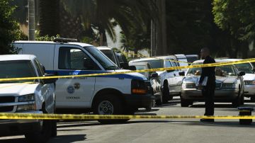 Police and investigators at the scene where three people killed during a shooting after a dispute at at a pop-up Jamaican restaurant in Los Angeles on October 15, 2016. Three people were killed and at least a dozen more injured, police said Saturday. One person has been arrested and police have launched a manhunt for another in connection with the deadly incident in West Adams, in the southwestern part of the metro area, said spokesman Lieutenant Chuck Springer. / AFP / Mark RALSTON (Photo credit should read MARK RALSTON/AFP via Getty Images)