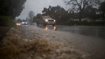 SUN VALLEY, CA - FEBRUARY 17: Motorists drive by waters as a powerful storm moves across Southern California on February 17, 2017 in Sun Valley, California. After years of severe drought, heavy winter rains have come to the state, and with them, the issuance of flash flood watches in Santa Barbara, Ventura and Los Angeles counties, and the evacuation of hundreds of residents from Duarte, California for fear of flash flooding from areas denuded by a wildfire last year. (Photo by David McNew/Getty Images)