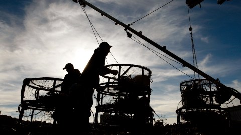 SAN FRANCISCO - NOVEMBER 15: Crab fishermen take a break from loading crab traps onto their boat at Fisherman's Wharf November 15, 2007 in San Francisco, California. On the official opening day of Dungeness crab season, fisherman remain in port today after California Governor Arnold Schwarzenegger postponed the opening of the crab season until December 1st citing public health concerns following a 58,000 gallon oil spill into the San Francisco bay. (Photo by Justin Sullivan/Getty Images)