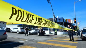 Police stand at a roadblock near Salvadore Castro Middle School in Los Angeles, California on February 1, 2018, where two students were wounded, one critically, in a school shooting. - Two 15-year-old students in Los Angeles were shot and wounded in class Thursday, according to witnesses and local media, in the latest school shooting to hit the United States. A boy was shot in the head, while a girl was hit in the wrist, according to reports from the scene. Local news agency CNS reported that a "young woman," possibly a fellow student, had been arrested. (Photo by Frederic J. Brown / AFP) (Photo by FREDERIC J. BROWN/AFP via Getty Images)