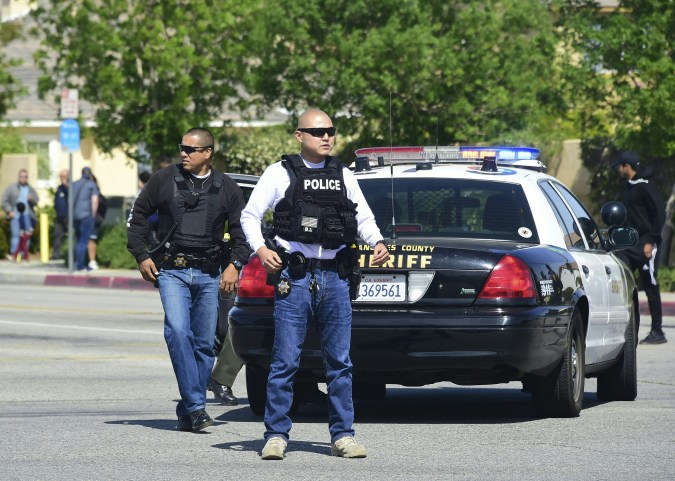 Police man an intersection May 11, 2018 following reports of shooting at Highland High School in Palmdale, 40 miles (65 kilometers) north of downtown Los Angeles. - Police arrested a man after reports of shootings at two schools near Los Angeles, the local sheriff's department and education officials said. The Los Angeles County Sheriff said one suspect had been detained "regarding the person with a gun" at Highland High School. Local news reports had earlier said that at least one person had been wounded. It was not immediately clear what type of weapon the man had. (Photo by Frederic J. BROWN / AFP) (Photo credit should read FREDERIC J. BROWN/AFP via Getty Images)