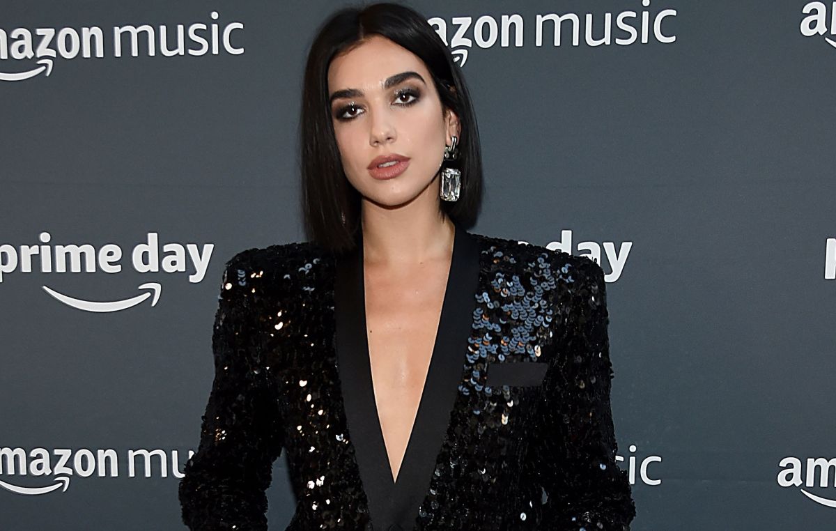 In a string thong and plush boots, Dua Lipa shows off her statuesque figure on the street