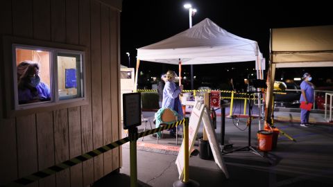 APPLE VALLEY, CALIFORNIA - JANUARY 05: Workers wait at triage tents and a patient information booth set up in the parking lot at Providence St. Mary Medical Center amid a surge in COVID-19 patients in Southern California on January 5, 2021 in Apple Valley, California. California has issued a new directive ordering hospitals with space to accept patients from other hospitals which have run out of ICU beds due to the coronavirus pandemic. The order could result in patients being shipped from Southern California to Northern California as Southern California continues to have zero percent of its remaining ICU (Intensive Care Unit) bed capacity. (Photo by Mario Tama/Getty Images)