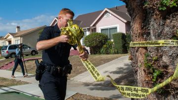 LOS ANGELES, CA - MAY 20: A police officer removes police tape from actor Michael Jace's home on May 20, 2014 in Los Angeles, California. The actor has been arrested for the murder of his wife . (Photo by Valerie Macon/Getty Images)