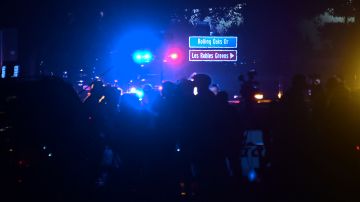 People gather as close as they can to the Borderline Bar and Grill in Thousand Oaks, California on November 8, 2018 as police vehicles closed off the area responding to a shooting. - Twelve people, including a police sergeant, were shot dead in a shooting at a night club close to Los Angeles, police said Thursday. All the victims were killed inside the bar in the suburb of Thousand Oaks late on Wednesday, including the officer who had been called to the scene, Sheriff Geoff Dean told reporters. The gunman was also dead at the scene, Dean added. The bar was hosting a college country music night. (Photo by Frederic J. BROWN / AFP) (Photo credit should read FREDERIC J. BROWN/AFP via Getty Images)