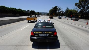 LOS ANGELES, CA - JULY 17: A California Highway Patrol cruiser waits to lead motorist on as construction workers remove barricades on the southbound Interstate 405 freeway before it re-opened ahead of schedule following a 10-mile shutdown of the freeway for bridge work on July 17, 2011 in Los Angeles, California. Los Angeles city officials advised residents to stay home or stay away from the area over the weekend fearing massive traffic jams of what has become known as "Carmageddon." which never materialized. (Photo by Kevork Djansezian/Getty Images)