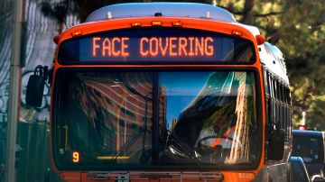 A Face Covering reminder is displayed on a bus in Los Angeles, California on November 30, 2020. - Los Angeles County's new stay-at-home restrictions took effect on November 30, 2020, one day after the county reported more than 5,000 new COVID-19 cases. (Photo by Frederic J. BROWN / AFP) (Photo by FREDERIC J. BROWN/AFP via Getty Images)