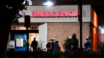 People wait outside the Emergency room of the Garfield Medical Center in Monterey Park, California on December 1, 2020. - A county-wide coronavirus regulations went into effect again on November 30 for three weeks amid ever increasing numbers of positive Covid-19 cases and fears of overwhelmed hospitals. Aid for restaurants will begin on December 3, with the start of the Keep Los Angeles County Dining Grant Program , allowing eligible restaurants which have lost business due to countywide coronavirus health regulations to apply for and receive up to $30,000 in aid. (Photo by Frederic J. BROWN / AFP) (Photo by FREDERIC J. BROWN/AFP via Getty Images)