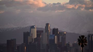 Snow-topped mountains stand behind the Los Angeles downtown skyline and Hollywood sign after sunrise following heavy rains as seen from the Kenneth Hahn State Recreation Area on December 29, 2020 in Los Angeles, California. (Photo by Patrick T. FALLON / AFP) (Photo by PATRICK T. FALLON/AFP via Getty Images)