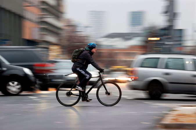 Bicycle and car commuters are seen crossing a busy intersection at Potsdamer Platz in central Berlin on December 7, 2020. - It's rush hour on a grey morning in Berlin and a stream of cyclists are charging along Friedrichstrasse, the fabled shopping street that runs through the city centre. (Photo by Odd ANDERSEN / AFP) (Photo by ODD ANDERSEN/AFP via Getty Images)