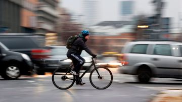 Bicycle and car commuters are seen crossing a busy intersection at Potsdamer Platz in central Berlin on December 7, 2020. - It's rush hour on a grey morning in Berlin and a stream of cyclists are charging along Friedrichstrasse, the fabled shopping street that runs through the city centre. (Photo by Odd ANDERSEN / AFP) (Photo by ODD ANDERSEN/AFP via Getty Images)