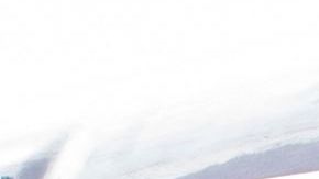 A man wearing a face mask drives a bus with a sign in the downtown area on March 8, 2021 in Los Angeles, California. (Photo by VALERIE MACON / AFP) (Photo by VALERIE MACON/AFP via Getty Images)