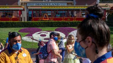 ANAHEIM, CA - APRIL 30: People enter Disneyland Park as it reopens for the first time since the COVID 19 pandemic forced the park to shut down last year on April 30, 2021 in Anaheim, California. California saw some of the highest infection rates in the nation over the winter but now enjoys some of the lowest. Los Angeles County, for example, is now expected to move from the orange tier of the states economic reopening system based on COVID-19 metrics to the least restrictive yellow tier, which would allow greater reopening freedoms, as early as next week. (Photo by David McNew/Getty Images)