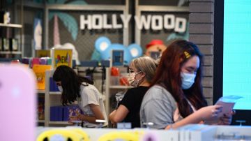 People shop at a store in Hollywood, California, on July 19, 2021, the second day of the return of the indoor mask mandate in Los Angeles County due to a spike in coronavirus cases. - The US surgeon general on July 18 defended a renewed mask mandate in Los Angeles, saying other areas may have to follow and adding that he is "deeply concerned" about the Covid-19 outlook in the fall. LA County reported another 1,233 Covid-19 cases, the 11th consecutive day the number has topped 1,000. (Photo by Robyn Beck / AFP) (Photo by ROBYN BECK/AFP via Getty Images)