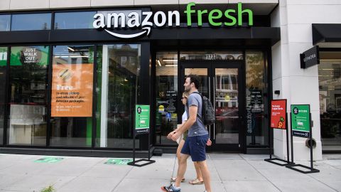 People walk past an Amazon Fresh store in Washington, DC, on August 26, 2021. (Photo by Nicholas Kamm / AFP) (Photo by NICHOLAS KAMM/AFP via Getty Images)