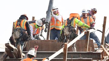 Construction workers pour concrete on the last of 20 arches for the Sixth Street Viaduct project in Los Angeles, California on January 18, 2022. - The original stucture was built in 1932 and is famed for an appearance in the Hollywood movie "Grease." (Photo by Frederic J. BROWN / AFP) (Photo by FREDERIC J. BROWN/AFP via Getty Images)