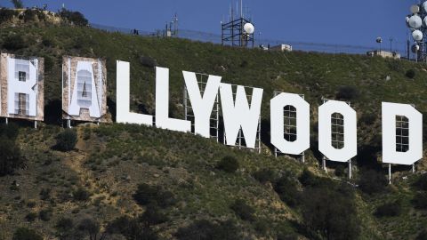 Banners, to read "Rams House", are installed over the Hollywood sign in Los Angeles, California, on February 14, 2022. - The temporary display will be installed to celebrate the Los Angeles Rams victory over the Cincinnati Bengals in Superbowl LVI on February 13. (Photo by Patrick T. FALLON / AFP) (Photo by PATRICK T. FALLON/AFP via Getty Images)