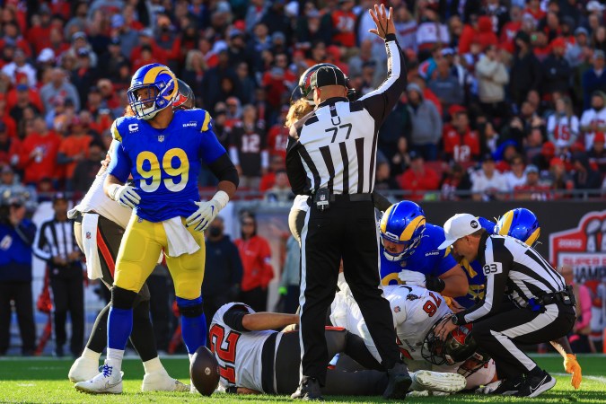 TAMPA, FLORIDA - JANUARY 23: Aaron Donald #99 of the Los Angeles Rams reacts after sacking Tom Brady #12 of the Tampa Bay Buccaneers in the second quarter in the NFC Divisional Playoff game at Raymond James Stadium on January 23, 2022 in Tampa, Florida. (Photo by Mike Ehrmann/Getty Images)