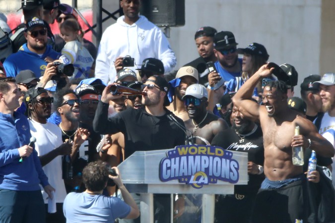 LOS ANGELES, CALIFORNIA - FEBRUARY 16: Matthew Stafford (L, Center) of the Los Angeles Rams celebrates on stage during the Super Bowl LVI Victory Parade on February 16, 2022 in Los Angeles, California. (Photo by Katelyn Mulcahy/Getty Images)