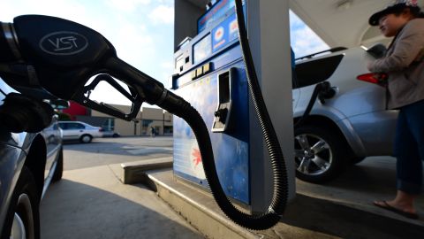 A driver fills up her tank as cars pull up to a gas station in Alhambra, east of downtown Los Angeles, on October 10, 2012 in California, where the average price for a gallon of regular gasoline rose to an all-time high earlier this week, prompting calls for a federal investigation into the price spike. AFPHOTO / Frederic J. BROWN (Photo credit should read FREDERIC J. BROWN/AFP/GettyImages)