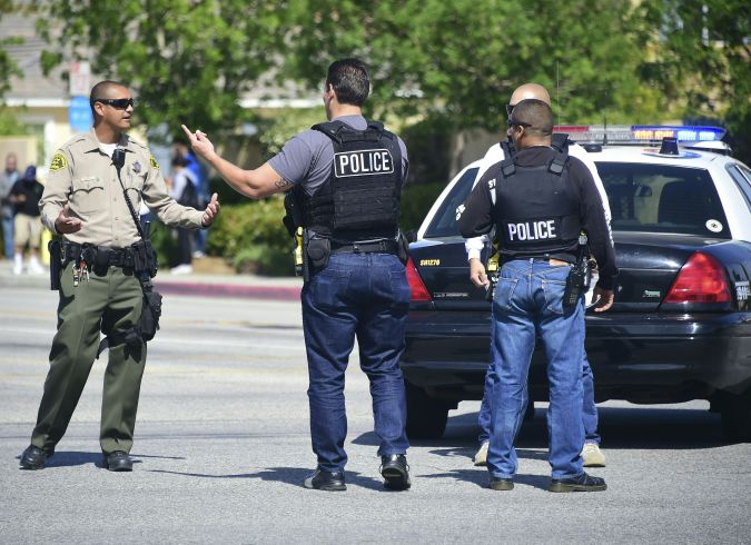 Police man an intersection May 11, 2018 following reports of shooting at Highland High School in Palmdale, 40 miles (65 kilometers) north of downtown Los Angeles. - Police arrested a man after reports of shootings at two schools near Los Angeles, the local sheriff's department and education officials said. The Los Angeles County Sheriff said one suspect had been detained "regarding the person with a gun" at Highland High School. Local news reports had earlier said that at least one person had been wounded. It was not immediately clear what type of weapon the man had. (Photo by Frederic J. BROWN / AFP) (Photo credit should read FREDERIC J. BROWN/AFP via Getty Images)