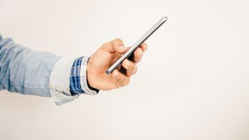 Foto de la mano de una persona sosteniendo un teléfono inteligente