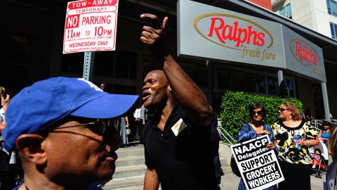 LOS ANGELES, CA - JULY 27: Terrell Dixon (C), a Ralphs grocery store cashier, joins NAACP members who attending the NAACP's 102nd annual national convention nearby Los Angeles Convention Center in labor march and a rally in front of the grocery store on July 27, 2011 in Los Angeles, California. The delegates marched from the Los Angeles Convention Center to the Ralphs grocery store in a show of support for the 62,000 workers who are in contract negotiations and threatening to strike Southern California's three major grocery chains Ralphs, Albertsons and Vons. (Photo by Kevork Djansezian/Getty Images)