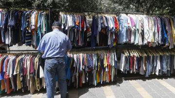 A Syrian man shops for clothes at a flea market in the capital Damascus on May 17, 2020, amid severe economic crisis that has been compounded by a coronavirus lockdown. - Prices have doubled over the past year, while the Syrian pound has reached record lows against the dollar, further driving up inflation. With most of the population living in poverty, Syrians have increasingly turned to flea markets to purchase clothes at a reasonable price. (Photo by LOUAI BESHARA / AFP) (Photo by LOUAI BESHARA/AFP via Getty Images)