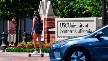 A student skateboards to campus at the University of Southern California (USC) in Los Angeles, California on August 25, 2020 where coronavirus cases have seen an alarming increase with more than 100 students in quarantine from cases originating in off-campus housing. (Photo by Frederic J. BROWN / AFP) (Photo by FREDERIC J. BROWN/AFP via Getty Images)