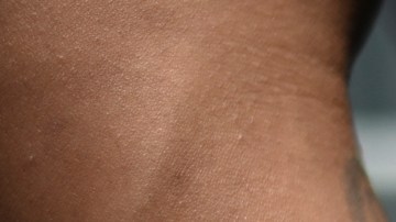A member of "Mara 18" gang stands handcuffed during an inspection at Centro Preventivo de Hombres prison, after the release of three guards of the penitentiary system (SP) in Guatemala City on September 4, 2020. - Guatemalan gang members on Friday released three prison guards who had been taken hostage in a jail in the capital, in rejection of the transfer of criminal gang leaders to other prisons, the government said. (Photo by Johan ORDONEZ / AFP) (Photo by JOHAN ORDONEZ/AFP via Getty Images)